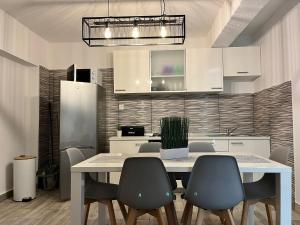 a dining room with a table and chairs and a kitchen at Apartment Potocnica 222a in Novalja