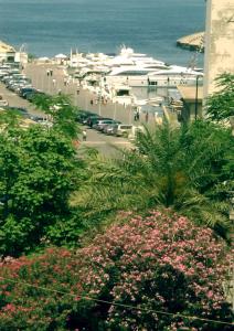 a view of a street with cars and the ocean at Regis Hotel in Beirut