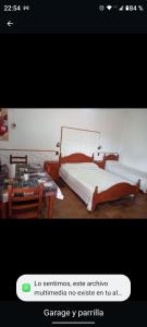 a picture of a bedroom with a bed and a table at Géminis ll in Colón