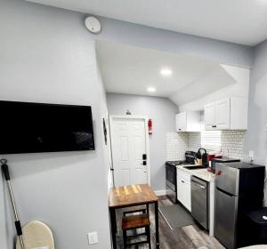 a kitchen with white cabinets and a black refrigerator at Green Roof House Studio in Lakeland