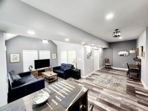 a living room with a couch and a tv at Green Roof House in Lakeland