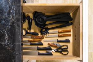 a wooden box filled with different types of scissors at Private Room #3 in a 4 bedroom Guest House in Roma Norte, Mexico City in Mexico City