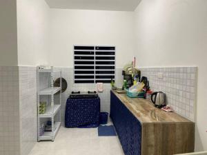 a kitchen with a counter and a sink in it at Homestay AZ in Batu Gajah