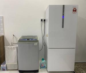 two refrigerators sitting next to each other in a room at Homestay AZ in Batu Gajah