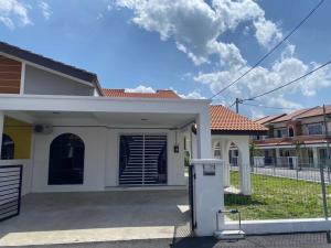 a house with a refrigerator in front of it at Homestay AZ in Batu Gajah