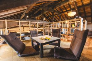 a dining room with a table and chairs at ako house in Goto