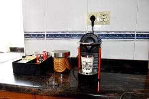a kitchen counter with a fire extinguisher on a counter at Casa Cal da Rosins in Muxia +37 photos