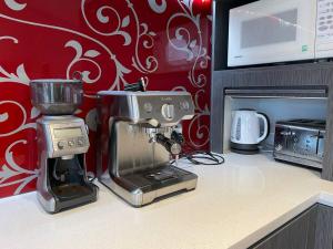 a kitchen counter with a mixer and a microwave at Mangawhai Heads Paradise in Mangawhai +7 photos