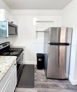 a kitchen with a stainless steel refrigerator and a stove at blue door house grand studio in Lakeland +13 photos