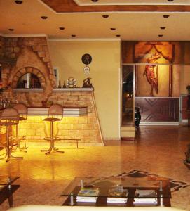 a living room with a stone fireplace and a table at Galini Palace in Athens