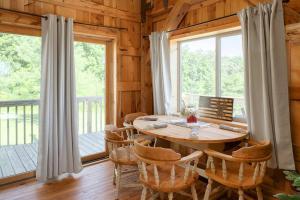 a dining room with a table and chairs and windows at The Rustic Retreat in Pearl City +20 photos