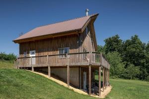 a large wooden barn on a hill in a field at The Rustic Retreat in Pearl City