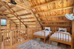a log cabin with two beds in a room at The Rustic Retreat in Pearl City