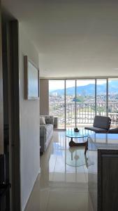 a living room with a couch and a glass table at Estadía Familiar in Ibagué
