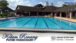 a swimming pool at the khan ranch hotel foodcourt at Ninizam Kemaman Cukai Homestay in Cukai