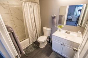 a bathroom with a toilet and a sink and a shower at Spacious 2-Bedroom Townhouse with Pool & Private Patio in Central Las Vegas in Las Vegas +10 photos