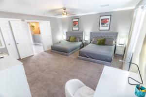 a living room with two beds and a couch at Spacious 2-Bedroom Townhouse with Pool & Private Patio in Central Las Vegas in Las Vegas