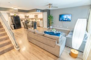 a living room with a couch and a kitchen at Spacious 2-Bedroom Townhouse with Pool & Private Patio in Central Las Vegas in Las Vegas