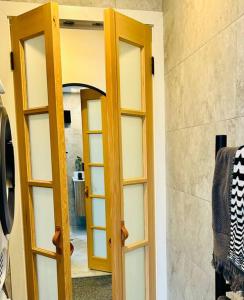 a wooden door with a mirror in a room at First Tracks Studio in Thredbo +18 photos