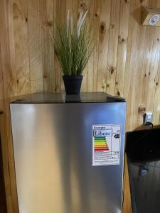 a refrigerator with a potted plant on top of it at Casa al mare uno - Matanzas y Pupuya in Navidad