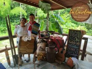 a man and a woman standing in front of a table at Cabaña La Carolina in Ibagué