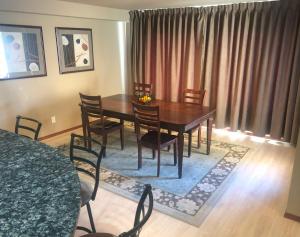 a dining room with a wooden table and chairs at Lake Chelan Executive Condo in Chelan