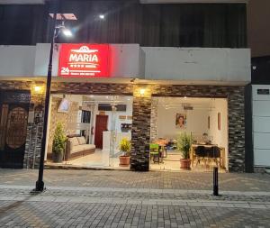 a store with a sign on the front of it at Hostal María - Otavalo in Otavalo
