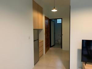 a hallway of a house with a kitchen and a television at LuxNar FF Sea in La Gaulette
