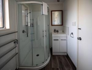 a bathroom with a glass shower and a sink at River Retreat - Lake Tekapo in Lake Tekapo +8 photos