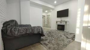 a living room with a couch and a television at Apartament de lux, 2 dormitoare! in Chişinău