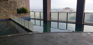 a building with a pool of water and windows at ETON BAYPARK MANILA by TRIPLE VIEW CONDOTEL in Manila