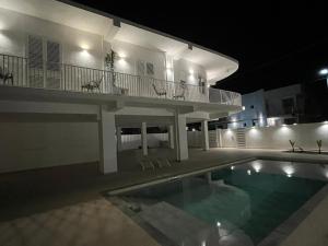 a house with a swimming pool at night at B&B La Dea in Marzamemi +10 photos