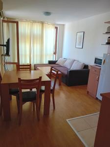 a living room with a table and a couch at Panorama Vigo Nesebar in Nesebar