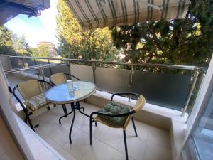 a patio with a table and chairs on a balcony at JOY Studio in Ravda