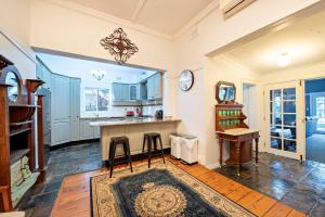 a kitchen with a counter and a table and a mirror at Kilbirnie - Stroll to CBD, Heritage, Sleeps 10 in Dubbo