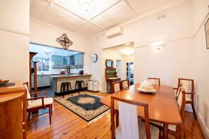 a dining room and kitchen with a table and chairs at Kilbirnie - Stroll to CBD, Heritage, Sleeps 10 in Dubbo +21 photos