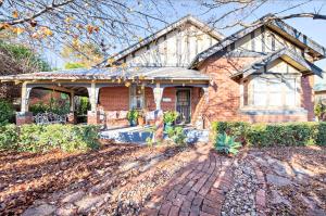 a brick house with a porch and a brick driveway at Kilbirnie - Stroll to CBD, Heritage, Sleeps 10 in Dubbo
