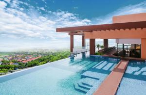 a swimming pool on the roof of a house with a view at La Vela Hue Hotel in Hue