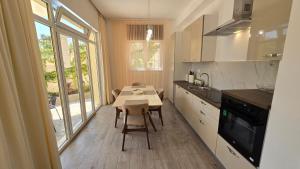 a small kitchen with a table and a table and chairs at Village Gals in Đenovići