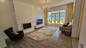 a living room with a couch and a tv at Village Gals in Đenovići