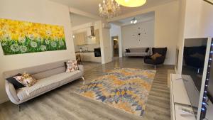 a living room with a couch and a painting on the wall at Village Gals in Đenovići +8 photos