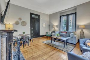 a living room with a couch and a fireplace at Ross & Ashley's Retreat (117 Marion St, #1) in Clarksville
