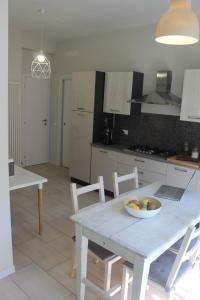 a kitchen with a table with a bowl of fruit on it at Academia in Cremona