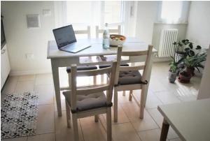 a dining room table with a laptop computer on it at Academia in Cremona +29 photos