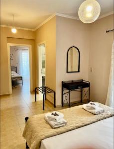 a bedroom with a bed and a mirror and a table at Valedina Rooms in Nikiana