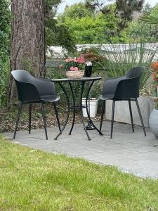 two chairs and a table in a garden at Dream Place in Iserlohn in Iserlohn
