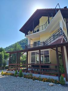 a large house with a balcony on top of it at Casa Astoria in Băile Herculane