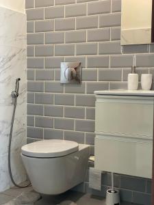 a bathroom with a white toilet and a sink at Stella Salalah in Salalah +4 photos