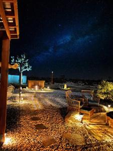 a group of chairs sitting on a patio at night at The Desert Shire Stargazing,Cold Plung & LargeSpa in Yucca Valley