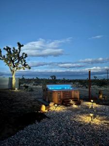 a building with a pool in the middle of a beach at The Desert Shire Stargazing,Cold Plung & LargeSpa in Yucca Valley